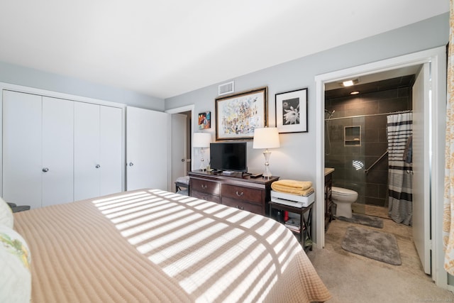 carpeted bedroom featuring ensuite bathroom and a closet