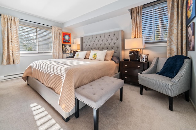 carpeted bedroom with baseboard heating and multiple windows