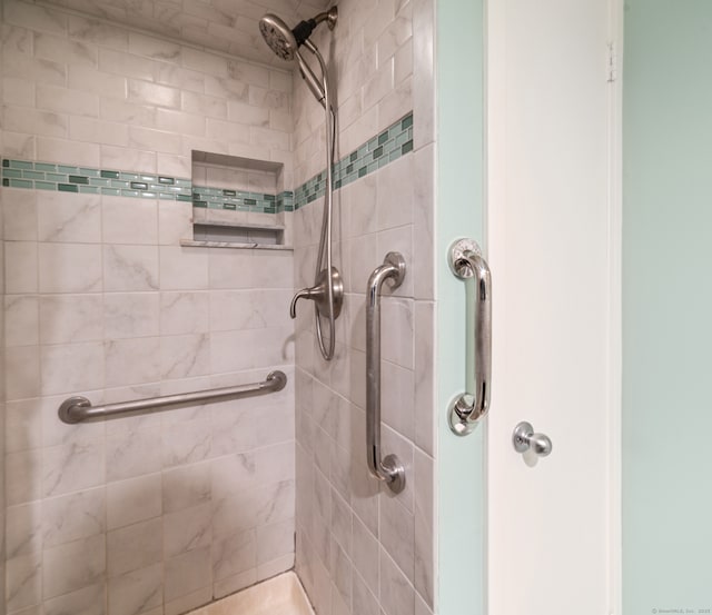 bathroom with a tile shower