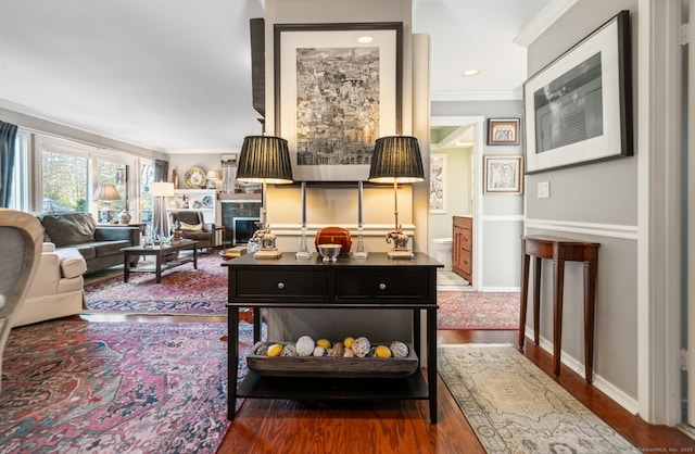 living room featuring dark hardwood / wood-style floors and ornamental molding