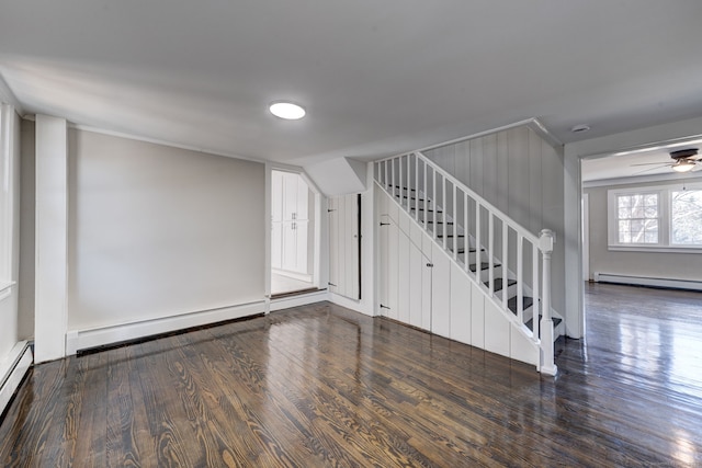 unfurnished room featuring ceiling fan, a baseboard heating unit, and dark hardwood / wood-style floors