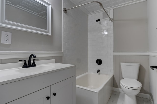 full bathroom featuring tiled shower / bath, vanity, and toilet