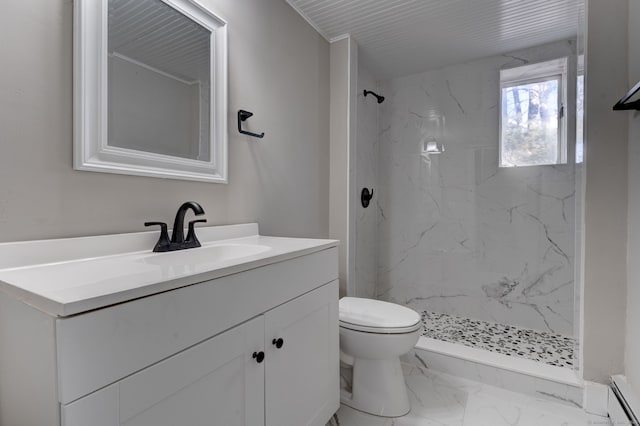 bathroom featuring vanity, toilet, and a tile shower