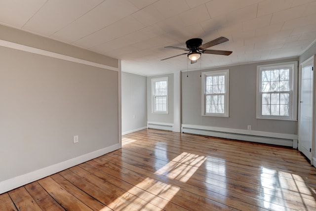 unfurnished room with ceiling fan, a baseboard radiator, and light wood-type flooring