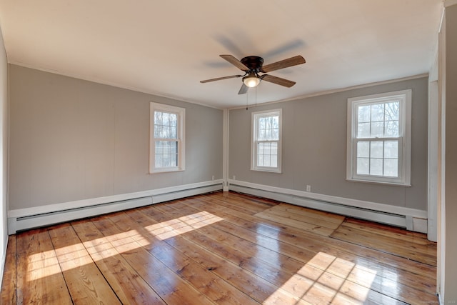 spare room featuring ceiling fan, a baseboard radiator, ornamental molding, and light wood-type flooring