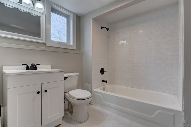 full bathroom with tiled shower / bath, vanity, and toilet