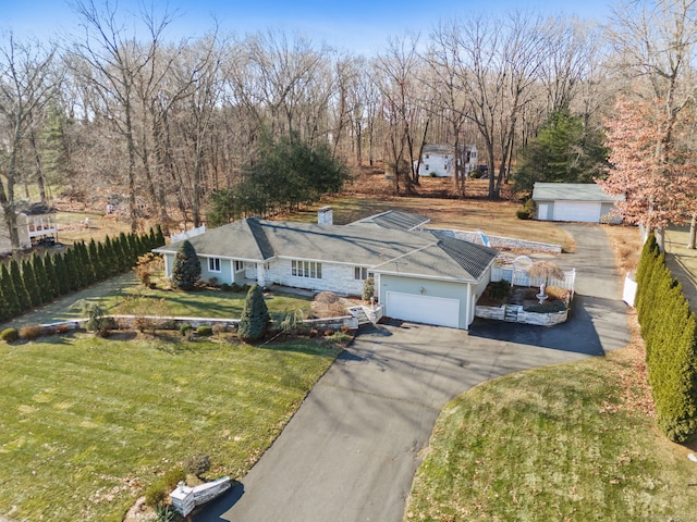 view of front of home featuring a garage and a front yard