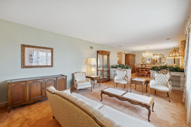 carpeted living room featuring an inviting chandelier