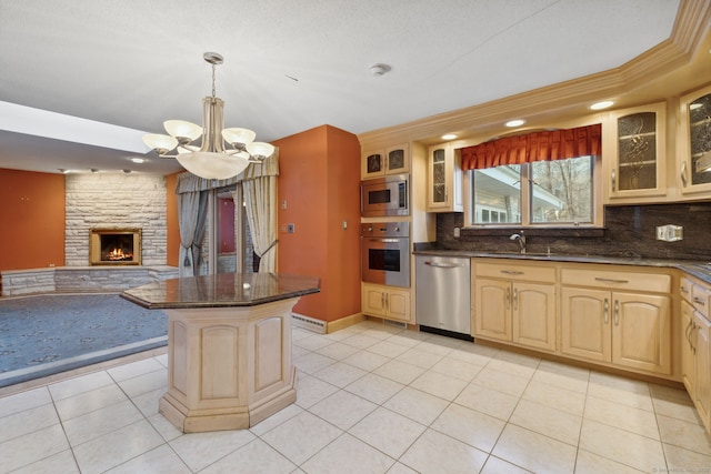 kitchen with decorative light fixtures, stainless steel appliances, backsplash, a chandelier, and light tile patterned flooring