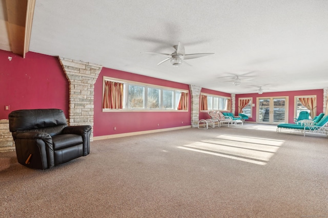 interior space featuring ceiling fan, a textured ceiling, and carpet flooring