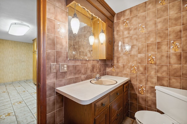 bathroom featuring tile walls, toilet, and vanity