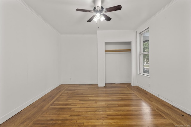 unfurnished bedroom with hardwood / wood-style flooring, ceiling fan, and ornamental molding