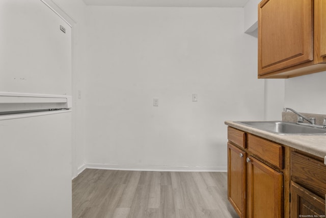 kitchen featuring light hardwood / wood-style flooring and sink