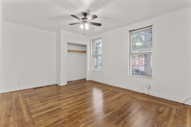 unfurnished bedroom with ceiling fan, wood-type flooring, and ornamental molding