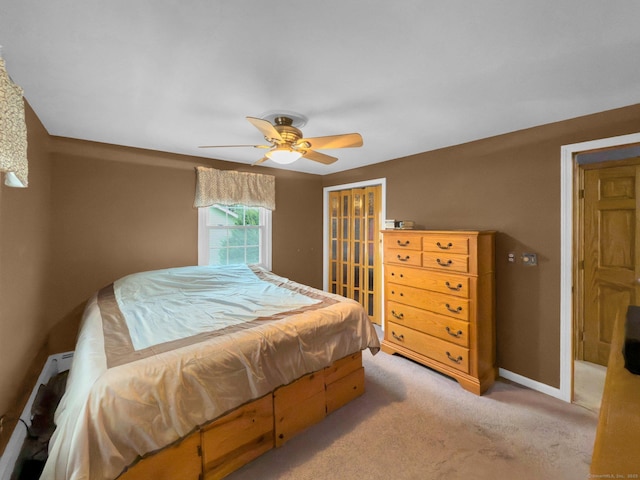 carpeted bedroom featuring a baseboard radiator, a closet, and ceiling fan