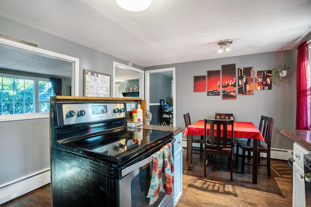 kitchen with a baseboard heating unit, dark wood-type flooring, and black / electric stove