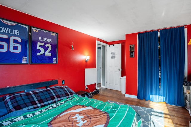 bedroom with hardwood / wood-style flooring