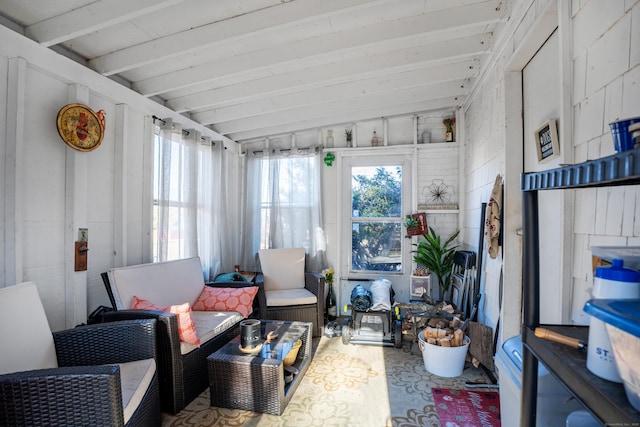 sunroom featuring vaulted ceiling with beams