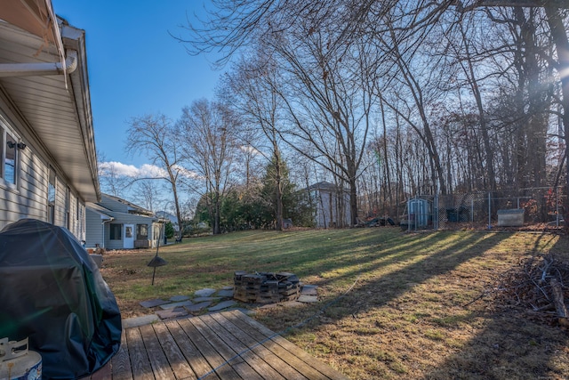 view of yard featuring a fire pit and a deck