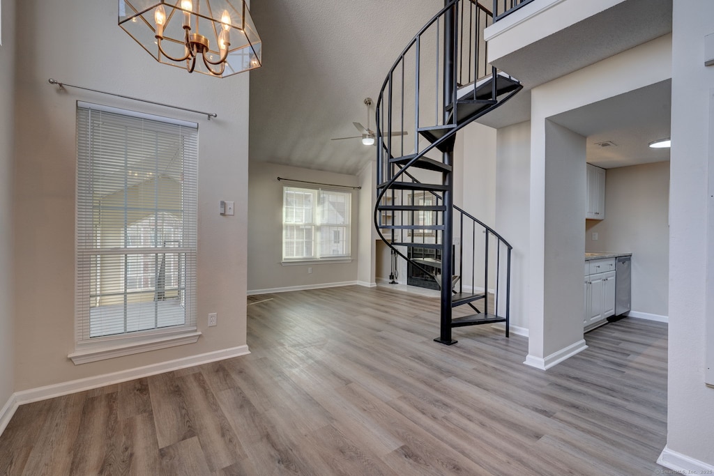 entryway featuring a notable chandelier, a high ceiling, and light hardwood / wood-style floors