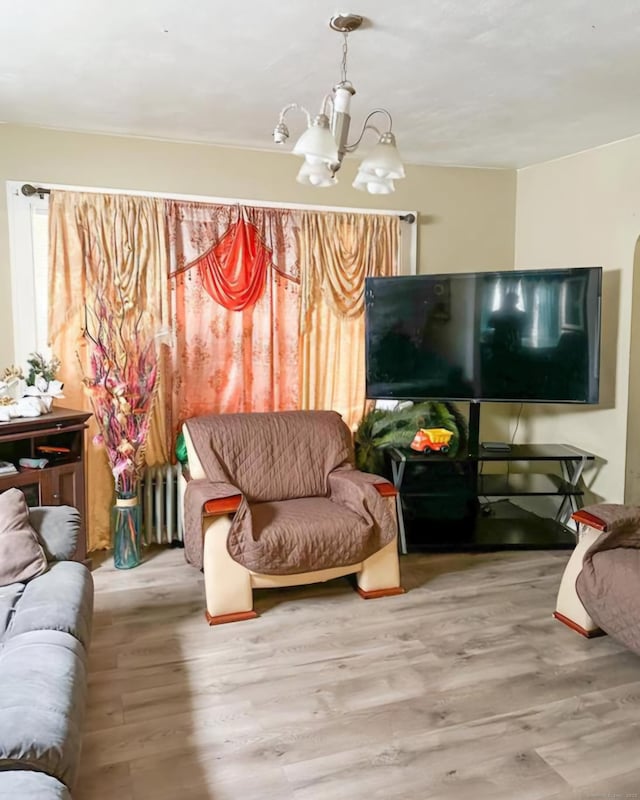 living room featuring a chandelier and hardwood / wood-style flooring