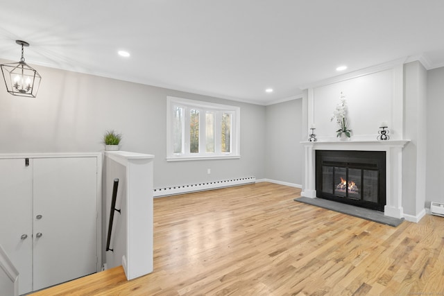 living room featuring a baseboard radiator, ornamental molding, light hardwood / wood-style floors, and a notable chandelier