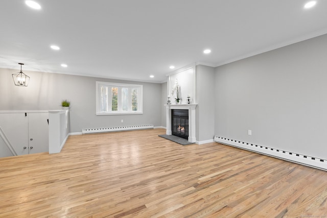 unfurnished living room with a notable chandelier, crown molding, light hardwood / wood-style flooring, and a baseboard radiator