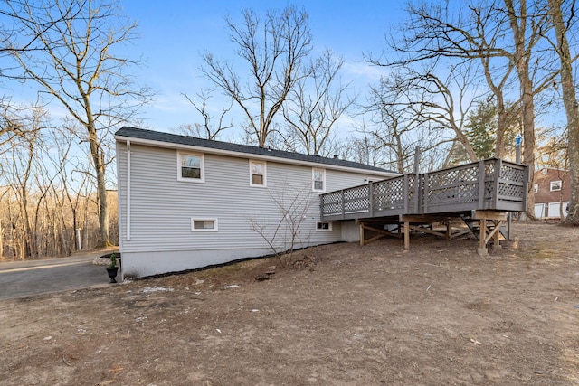 back of house featuring a wooden deck