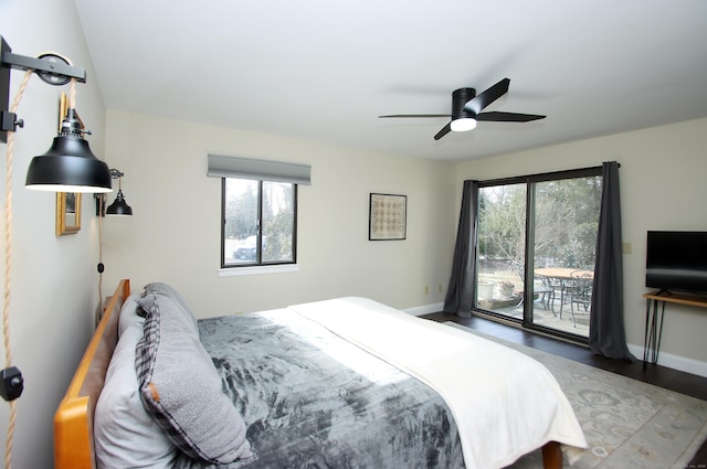 bedroom featuring ceiling fan, wood-type flooring, and access to outside