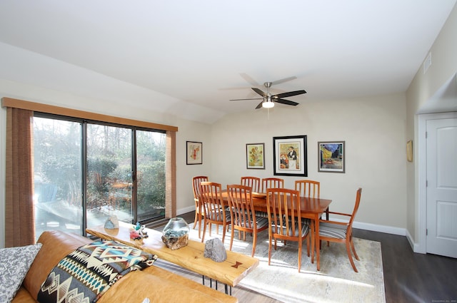 dining space with ceiling fan, dark hardwood / wood-style floors, and lofted ceiling