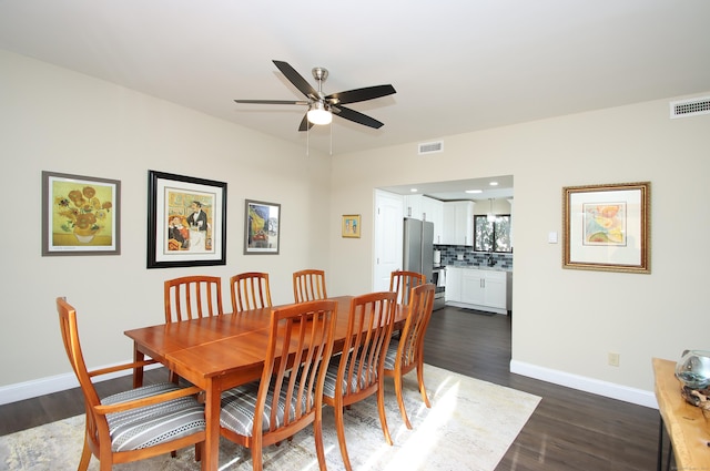 dining space featuring ceiling fan and dark wood-type flooring