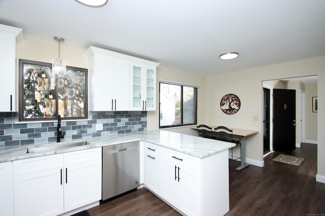 kitchen featuring dishwasher, pendant lighting, kitchen peninsula, sink, and white cabinetry