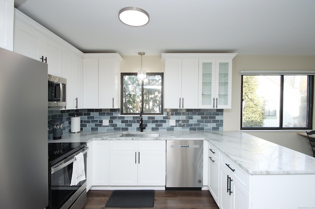 kitchen featuring light stone countertops, sink, white cabinetry, and appliances with stainless steel finishes