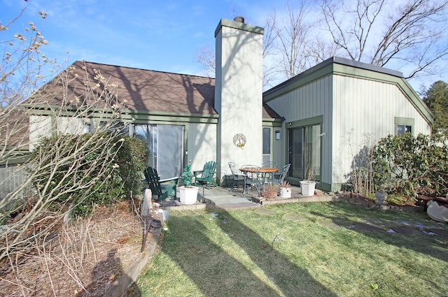 back of house featuring a patio area and a yard