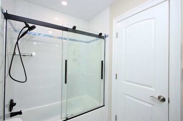 bathroom with shower / bath combination with glass door