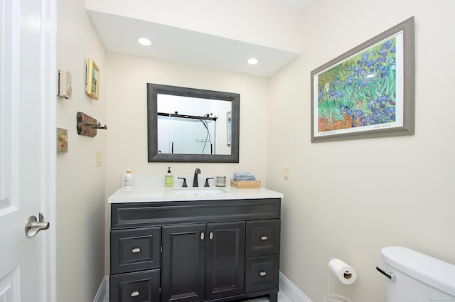 bathroom with toilet and vanity