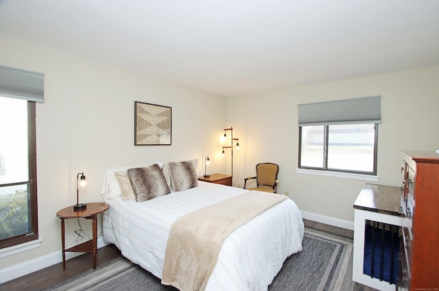 bedroom with dark hardwood / wood-style flooring