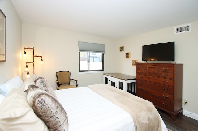 bedroom with dark hardwood / wood-style flooring