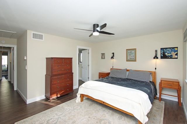 bedroom with ceiling fan and dark hardwood / wood-style flooring