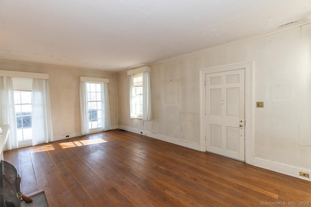 spare room featuring crown molding and dark wood-type flooring