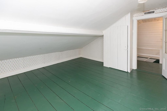 additional living space with lofted ceiling and dark hardwood / wood-style floors