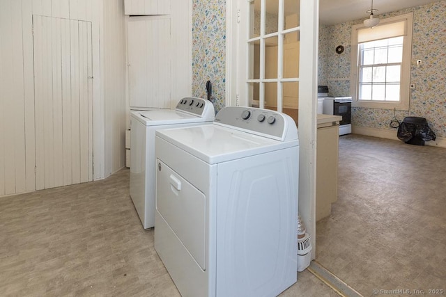 laundry area featuring separate washer and dryer and light hardwood / wood-style floors