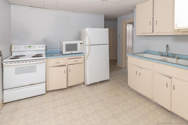 kitchen featuring white appliances and sink