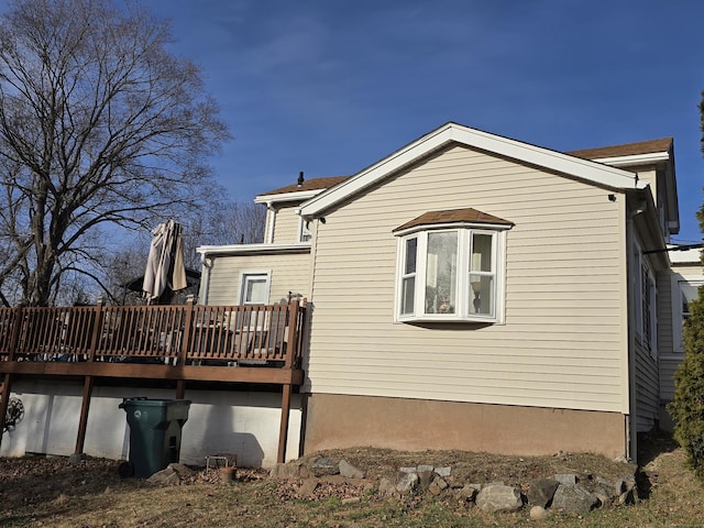 back of house with a wooden deck