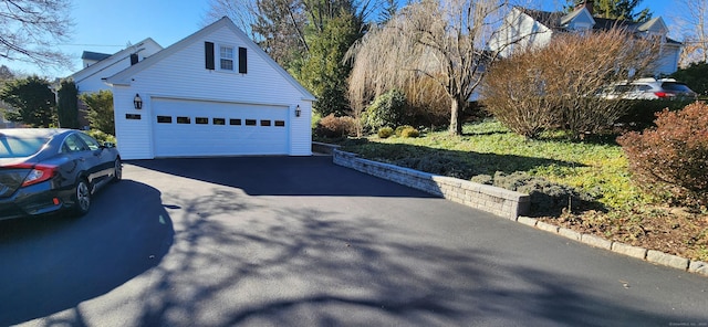 view of side of home with an outbuilding and a garage