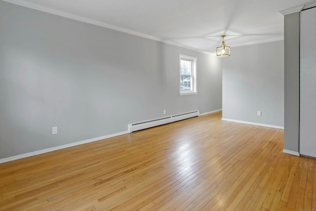 spare room with a chandelier, a baseboard radiator, light hardwood / wood-style flooring, and ornamental molding