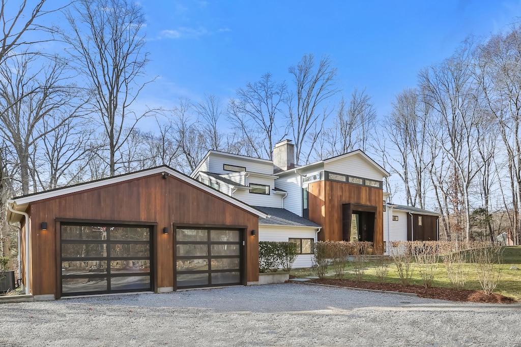 contemporary house with central air condition unit and a garage