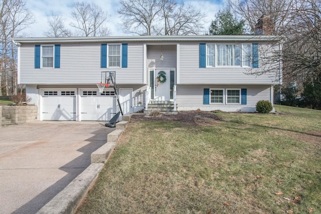 bi-level home with a garage and a front lawn