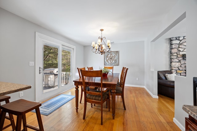 dining space with a chandelier and light hardwood / wood-style floors