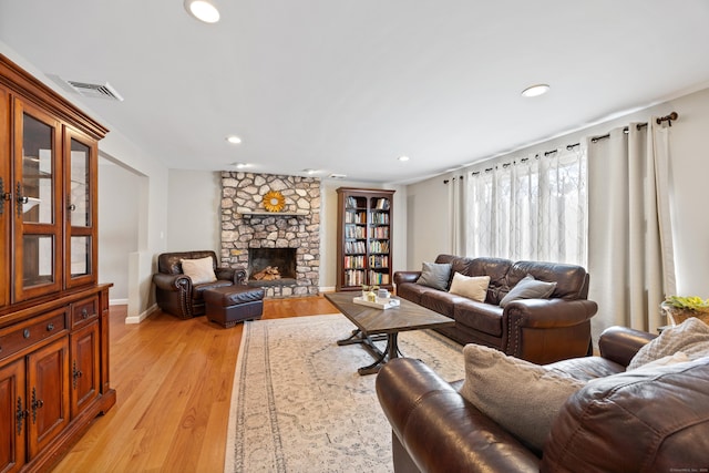 living room featuring a fireplace and light hardwood / wood-style floors